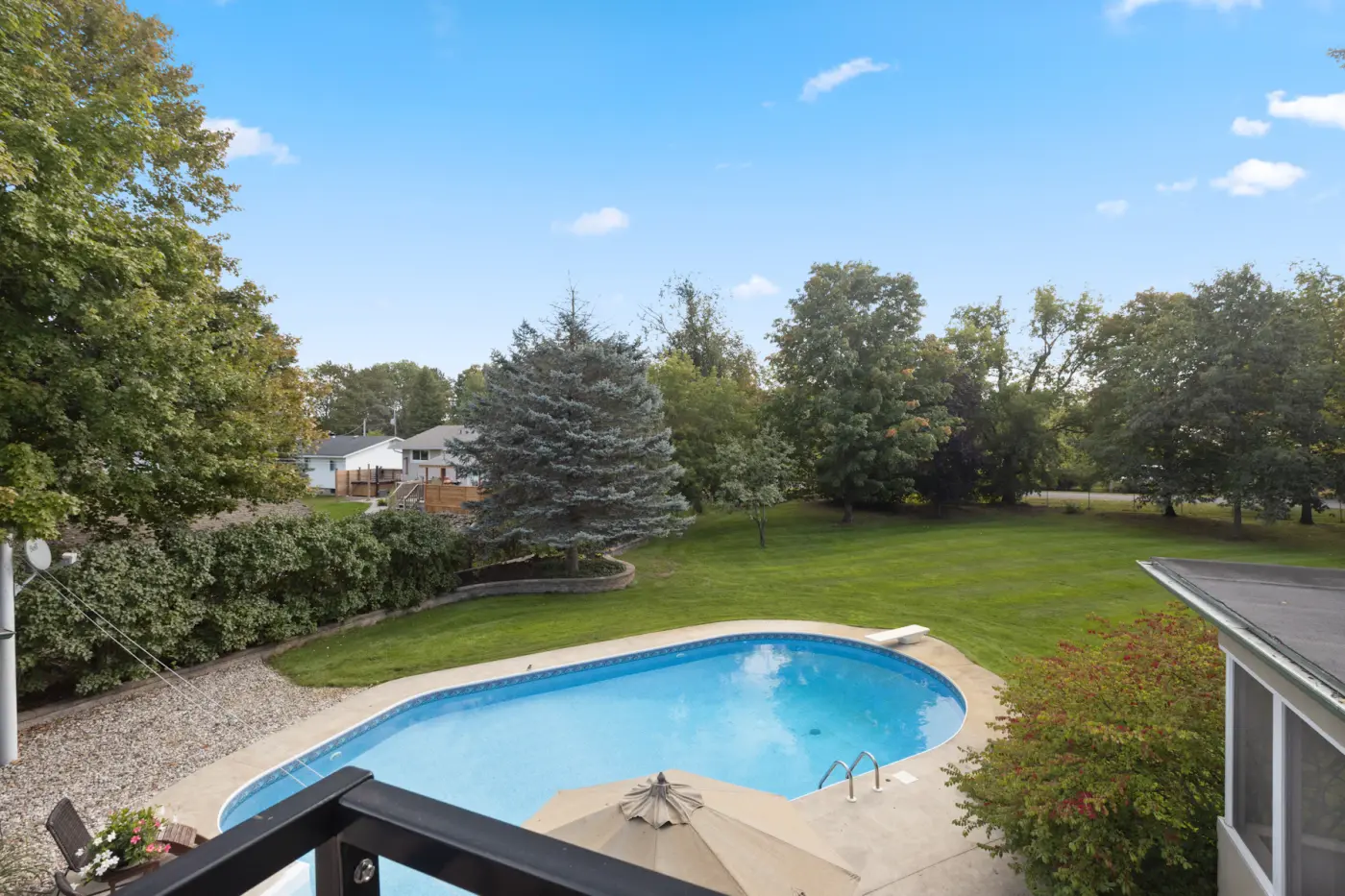 Residential backyard pool and patio at golden hour