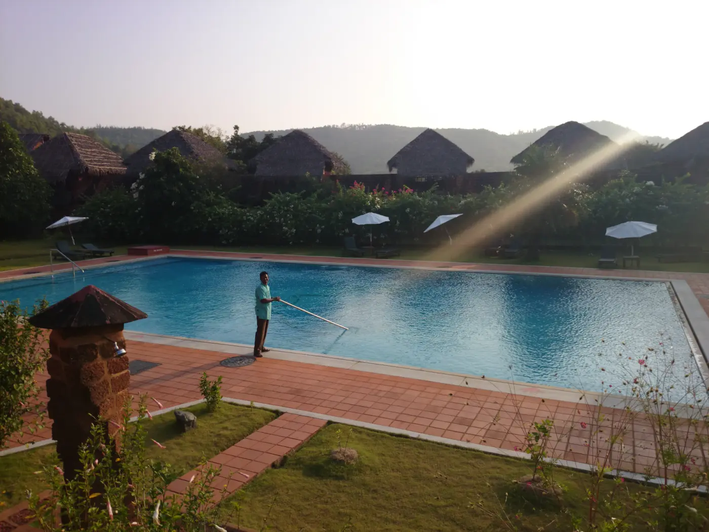 Pool technician working on a residential swimming pool deck